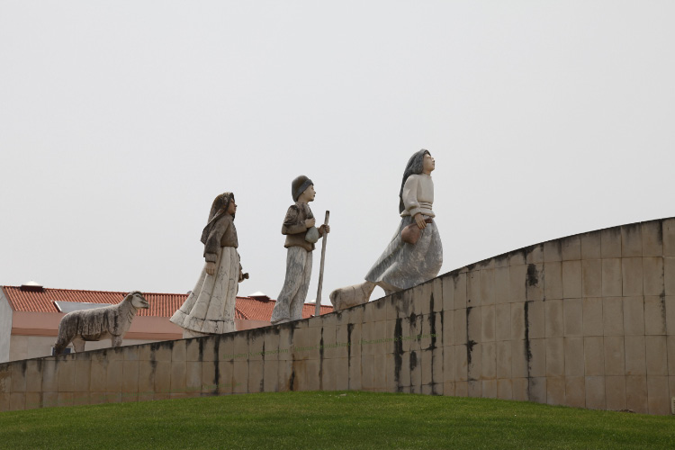 Three innocent shepherd children approach the Queen of Heaven